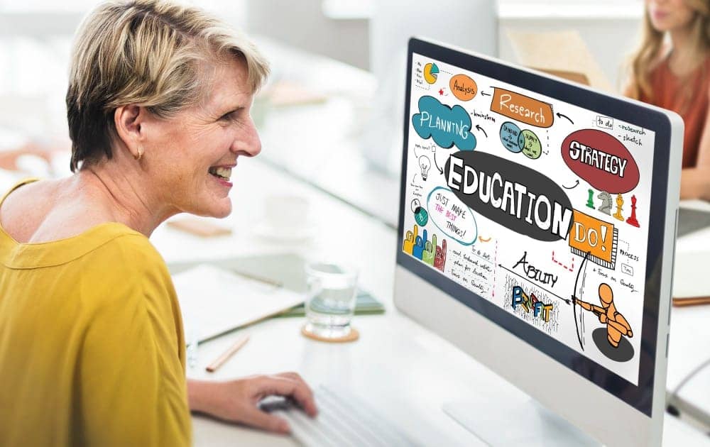 a woman looking at a computer screen edutainment