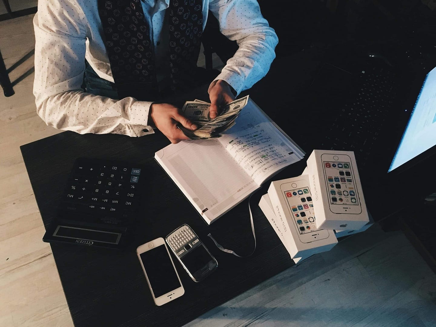 a person holding money and a book