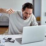 a man yelling at a laptop