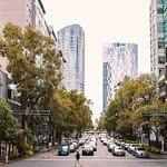 a street with cars and buildings in the background
