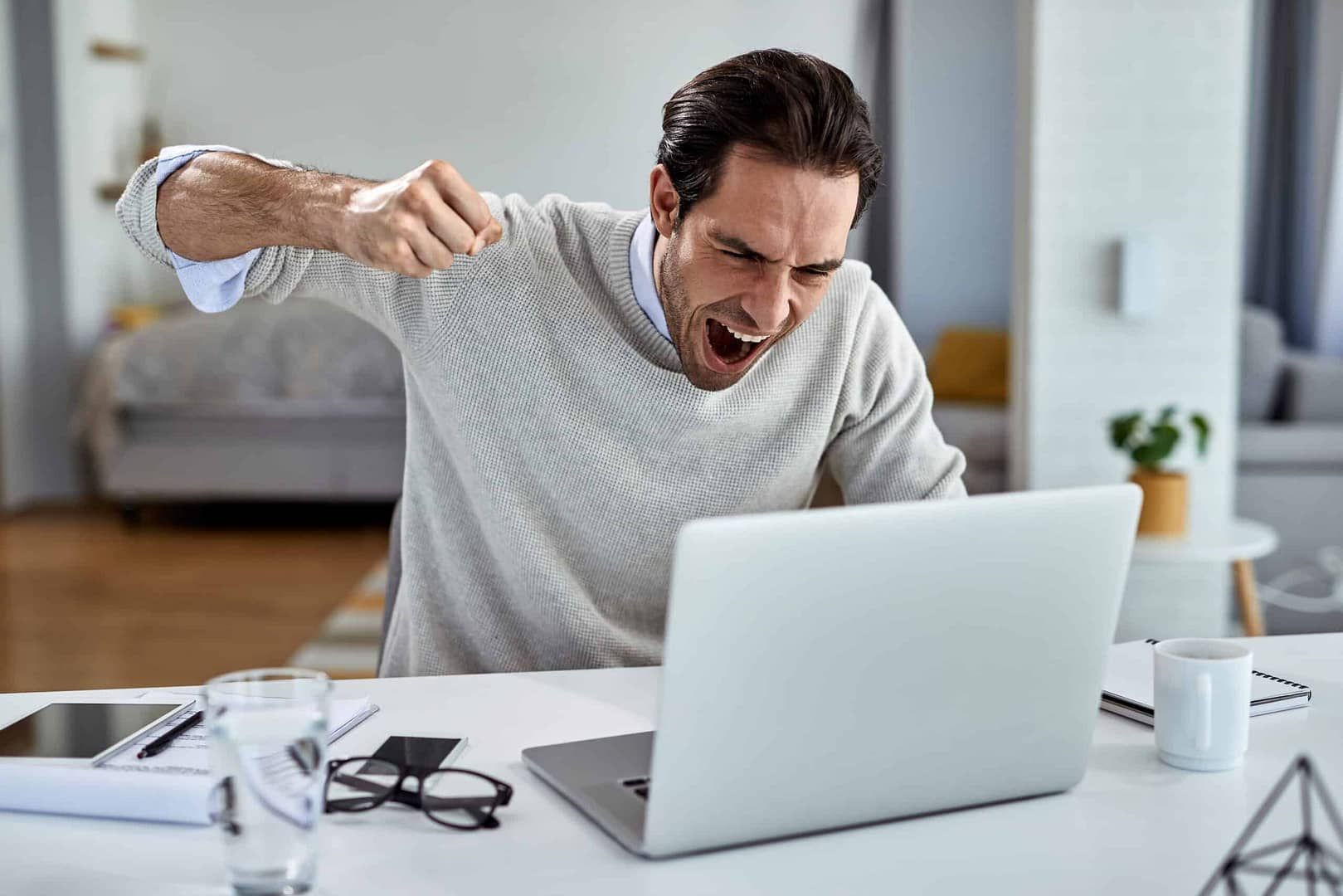 a man yelling at a laptop